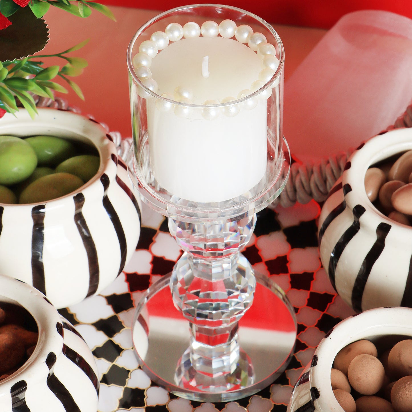 This gifting tray comes with 1 glass candle holder adorned with red flowers &amp; 4 ceramic abstract print jars filled with Oreo almonds , chocolate raisins, Pista flavored Cashew and Munchy masala cashew decorated in our MDF tray.