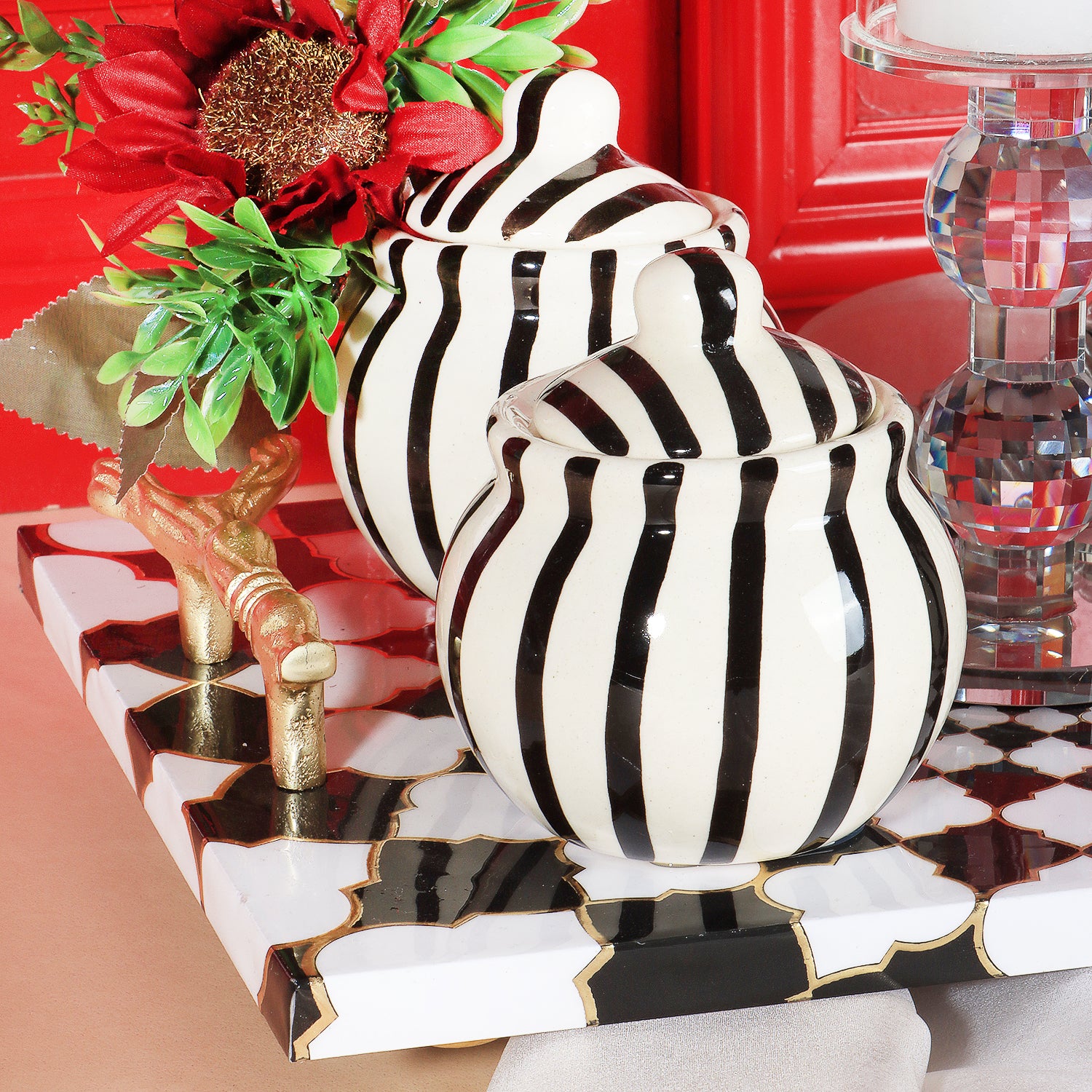 This gifting tray comes with 1 glass candle holder adorned with red flowers &amp; 4 ceramic abstract print jars filled with Oreo almonds , chocolate raisins, Pista flavored Cashew and Munchy masala cashew decorated in our MDF tray.